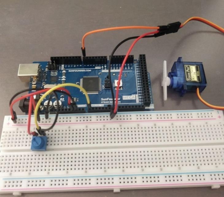 Breadboard photo showing the Arduino Mega, potentiometer, and servo motor wiring.