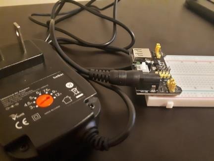 External power adapter connected to the breadboard power board.