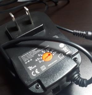 External power adapter with an adjustable voltage selector.