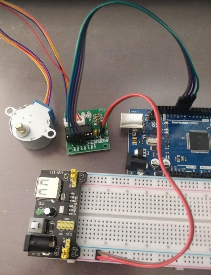 Completed stepper motor, driver, power board, breadboard, and Arduino wiring.